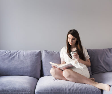 woman-reading-book-couch