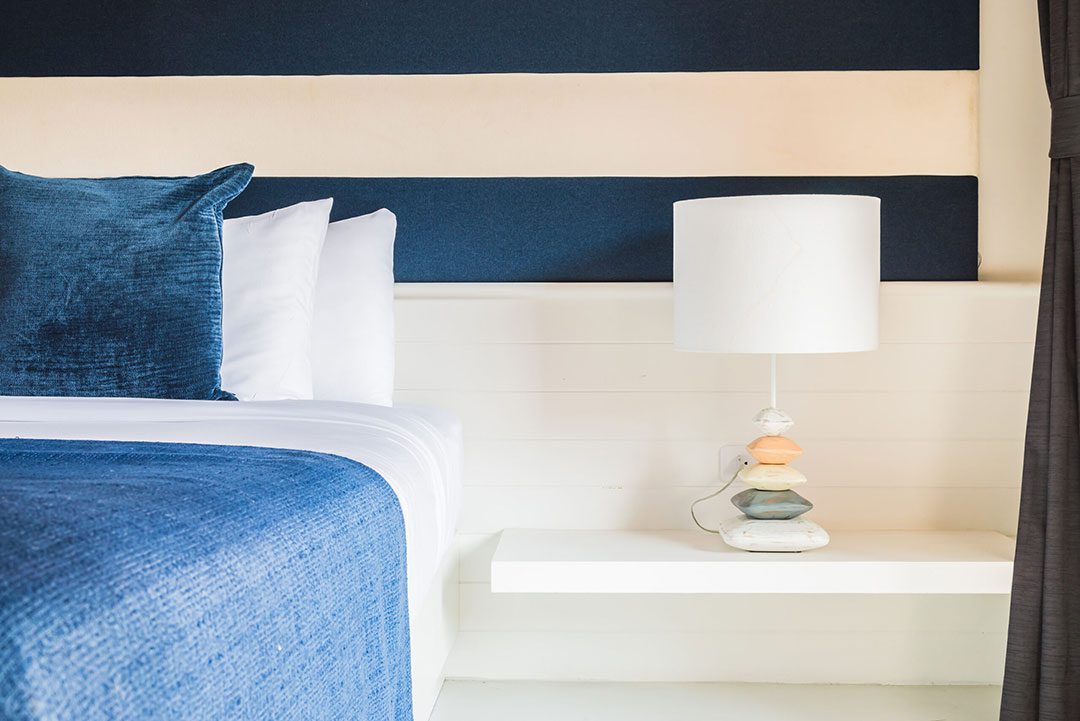 Bedroom lamp and nightstand detail, coastal bedroom — Riviera style
