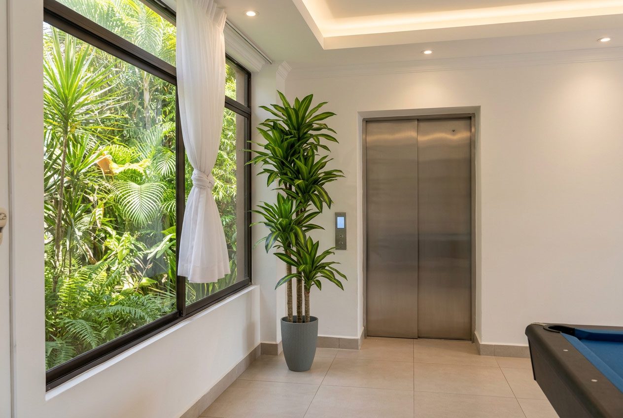 Realistic artificial plant styled in a Jacó condo interior — Riviera Home Furniture